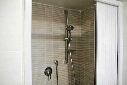 a shower with a shower head in a bathroom at Rooms Dimora Arco - Affitti Brevi Italia in Monte SantʼAngelo
