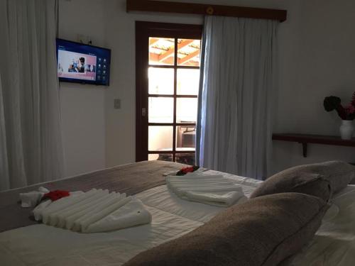 Cama ou camas em um quarto em Eden Praia Hotel