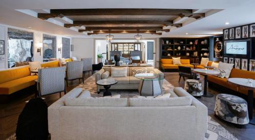 a living room with couches and chairs and a television at Hotel Amarano Burbank-Hollywood in Burbank
