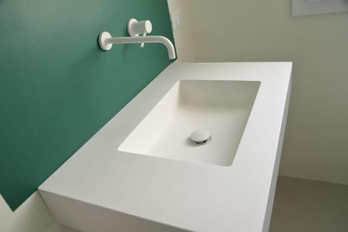 a bathroom sink with a faucet on a wall at Cocciu d’amuri in Terrasini