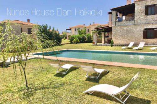 a villa with a swimming pool and a house at Ntinos House Elani Halkidiki in Siviri