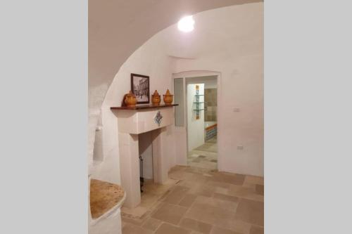 a hallway with a fireplace in a house at Trulli Relax a Martina Franca in Martina Franca