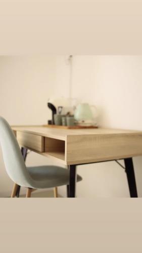 a desk with a chair and a wooden table at Cocciu d’amuri in Terrasini