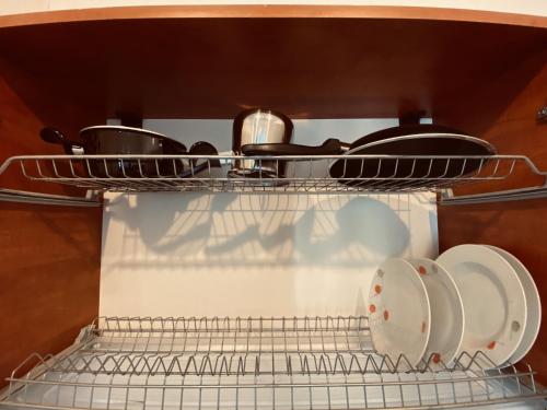 a rack with pots and pans in an oven at Lira Pacific Aparthotel in Constanţa