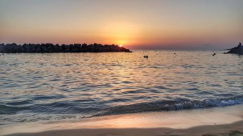 a sunset over the water at the beach at Pepi B&B in Santa Maria di Castellabate