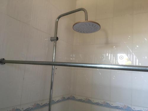 a shower with a glass door and a shower head at Dodoma Siesta Inn in Dodoma