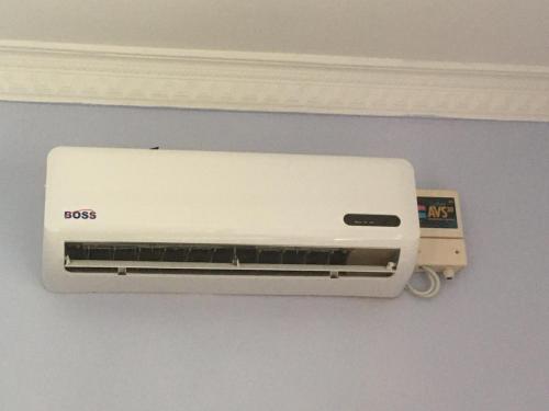 a white wall mounted air conditioner on a wall at Dodoma Siesta Inn in Dodoma