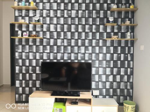 a wall with a flat screen tv in a room at Mcz homestay ipoh town 2room 7pax free wifi in Ipoh
