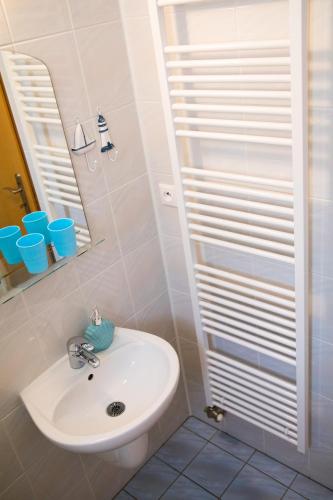 a bathroom with a sink and a mirror at Vila Adria in Hrabušice