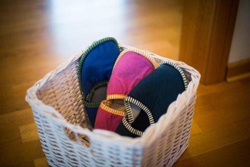 a pair of shoes in a basket on the floor at Rooms Ambrožič in Bled