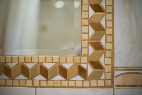a mirror on a wall in a bathroom at Rooms Ambrožič in Bled