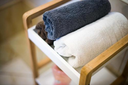 a pile of towels and a hat sitting on a chair at Rooms Ambrožič in Bled