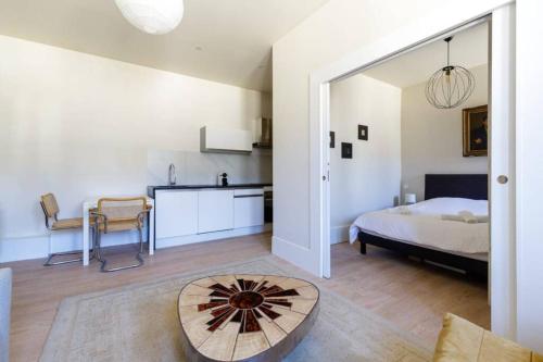 ein Schlafzimmer mit einem Bett und einem Tisch in einem Zimmer in der Unterkunft Magnifique appartement au cœur de la Petite France in Straßburg