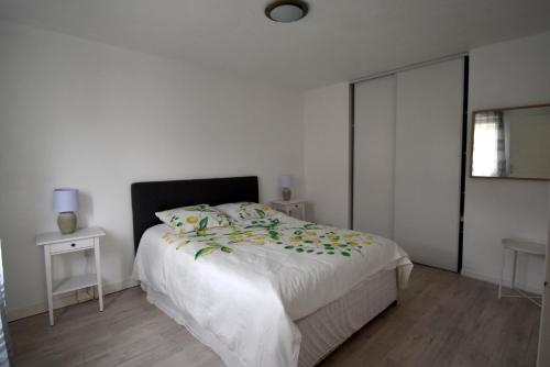1 dormitorio con 1 cama con sábanas blancas y ventana en Chez Patrick, en Grandcamp-Maisy