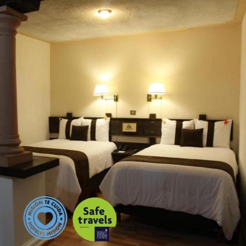 a hotel room with two beds in a room at Hotel Misión Xalapa in Xalapa