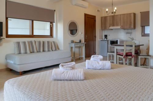 a bedroom with two beds with towels on them at Αlissachne Suites in Limniónas