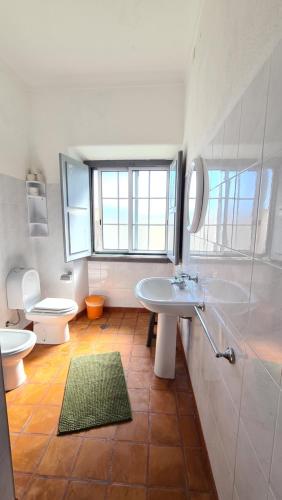 a bathroom with a sink and a toilet at Moradias Estação Radio Naval , Moradia Vila do Porto in Lajes das Flores