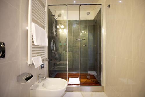 a bathroom with a shower and a toilet and a sink at Hotel Mercure Milano Solari in Milan