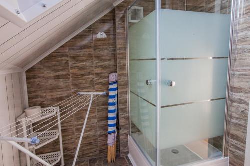 a bathroom with a glass refrigerator next to a staircase at PIKA Pokoje Gościnne in Władysławowo
