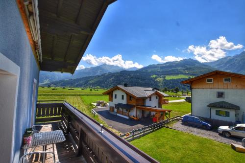 a balcony with a view of a house and mountains at Peters Panoramaappartment in Piesendorf