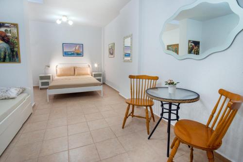 a living room with a bed and a table at Casa Costa for 7 guests near Fourka beach in Skala Fourkas