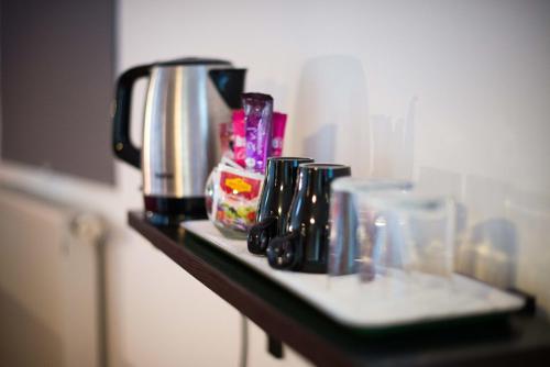 a counter with a coffee maker and other items on it at Rooms Ambrožič in Bled