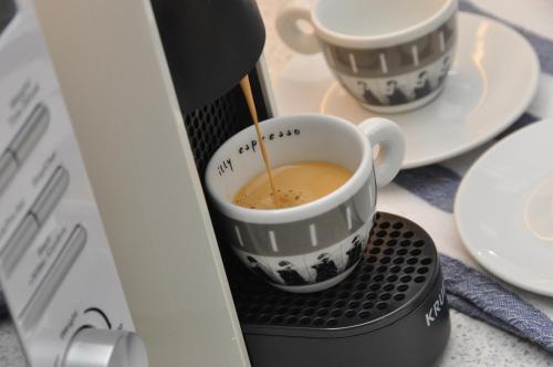 a coffee maker is making a cup of coffee at Bridge Street Apartments. Boutique Style Luxury, in the heart of Taunton. in Taunton