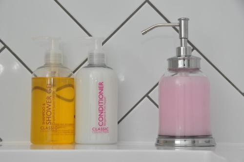 a group of three bottles sitting on a shelf at Bridge Street Apartments. Boutique Style Luxury, in the heart of Taunton. in Taunton