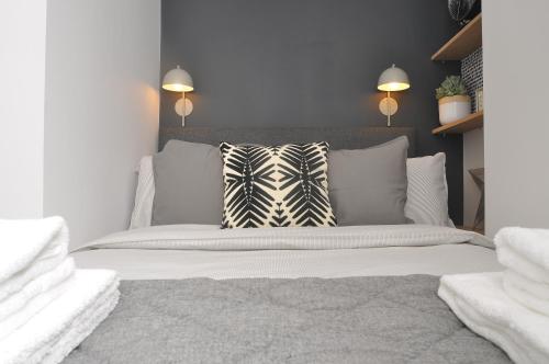 a bedroom with a white bed with a zebra pillow at Bridge Street Apartments. Boutique Style Luxury, in the heart of Taunton. in Taunton