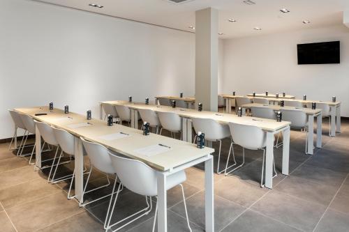 a row of tables and chairs in a room at B&B HOTEL Lisboa Aeroporto in Lisbon