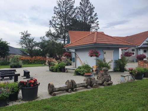 a house with a garden with a bench and flowers at u Ďurkových in Žabokreky nad Nitrou