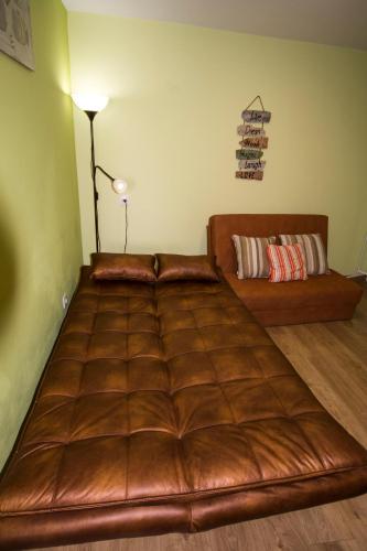 a large leather bed in a room with a lamp at Moinho do Prado in Vila Nova de Cerveira