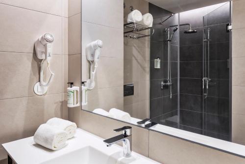 a bathroom with a sink and a shower at B&B HOTEL Lisboa Aeroporto in Lisbon