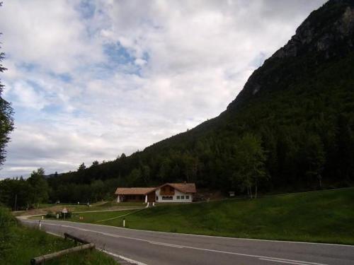 a house on the side of a road next to a mountain at Bar Ristorante Affittacamere Passo Durone in Coltura