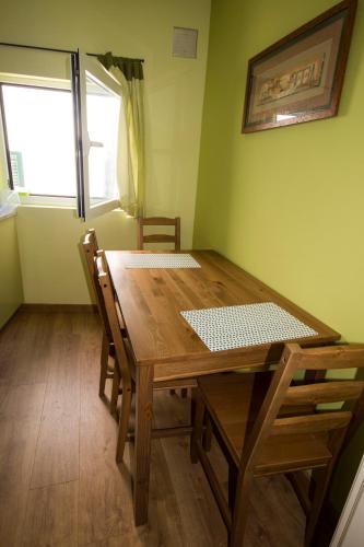 a dining room with a wooden table and chairs at Moinho do Prado in Vila Nova de Cerveira