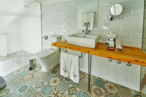 a bathroom with a sink and a toilet at Hotel Arrey Alella in Alella