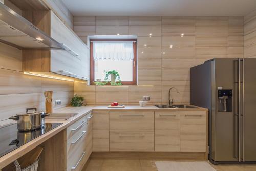 a kitchen with a refrigerator and a sink at Willa Wrzos in Zakopane