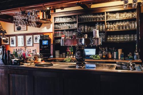 a bar with a lot of bottles of alcohol at Gasthaus zum Löwen in Frankfurt/Main