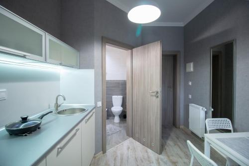 a bathroom with a sink and a toilet at Opera Passage Hotel & Apartments in Lviv
