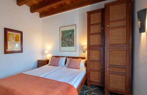 a bedroom with a bed and some wooden cabinets at El Inti 1 in Tinajo