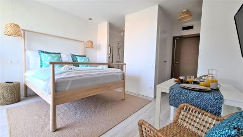 a bedroom with a bed and a desk with a table at Mandula Villa in Tihany
