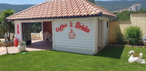 a white shed with a sign on the side of it at Apartmani Niksic in Herceg-Novi