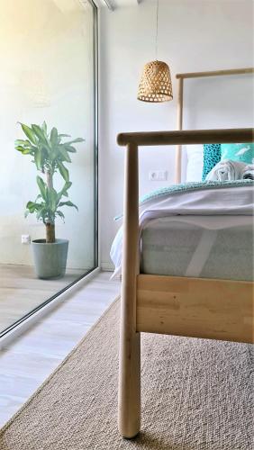 a bedroom with a bed and a potted plant at Mandula Villa in Tihany