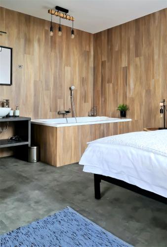a bedroom with a bath tub and a bed at Mandula Villa in Tihany