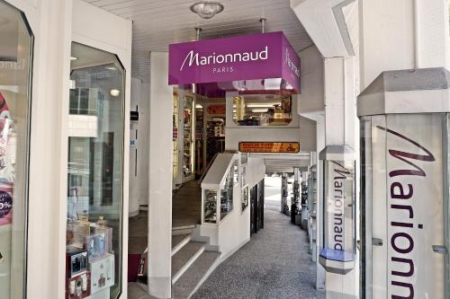 a store with a purple sign on the side of a building at Charmantes, gemütliches Studio, im Zentrum - C2 in St. Moritz