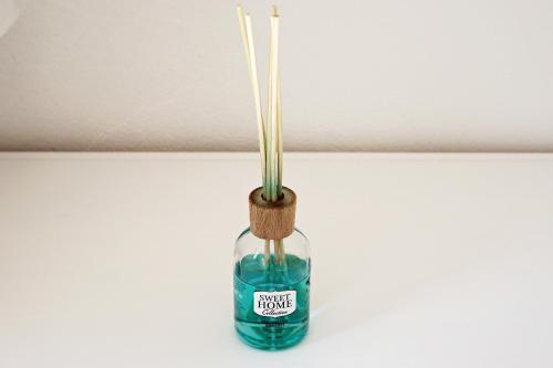 a bottle with bamboo sticks in it with a blue liquid at Charmantes, gemütliches Studio, im Zentrum - C2 in St. Moritz