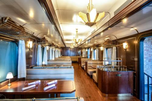 a dining car of a train with couches and tables at Hyatt Zilara Cap Cana - Adults Only in Punta Cana