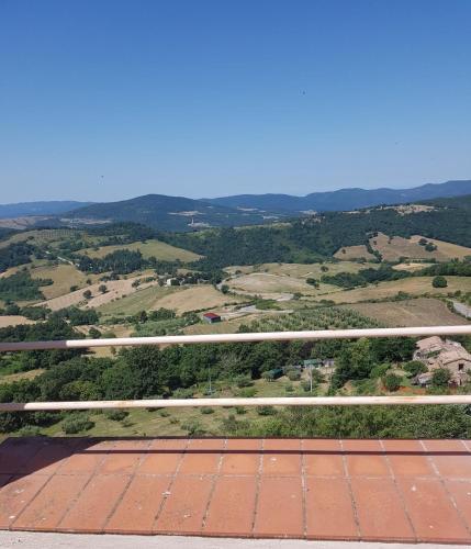 a view of a field from the top of a tennis court at Casa a Serrazzano in Serrazzano