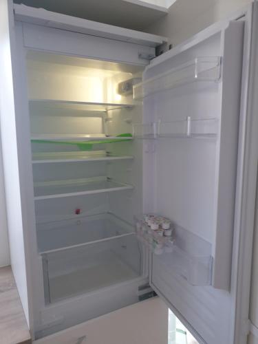 a white refrigerator with its door open and empty shelves at Apartment Hofacker in Pernegg an der Mur