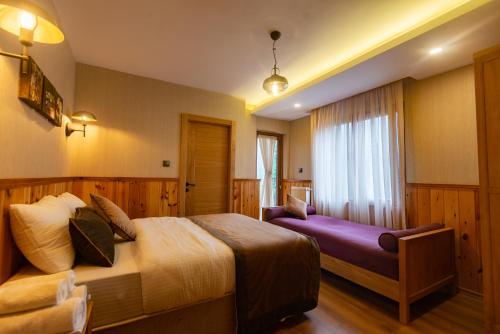 a hotel room with a bed and a window at Ayder Koru Hotel in Ayder Yaylasi